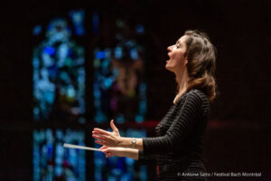 Gohar Manvelyan directing in front of stain glass window